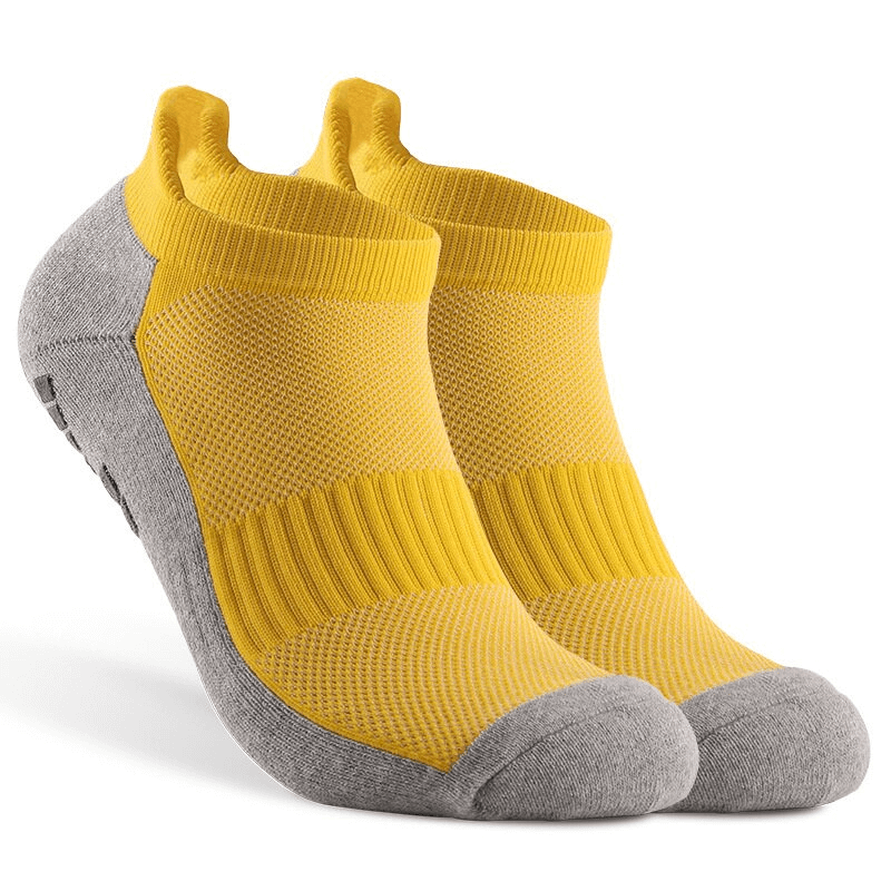 Yellow and gray non-slip sports socks with silicone soles for football, stylish and breathable design for secure play.